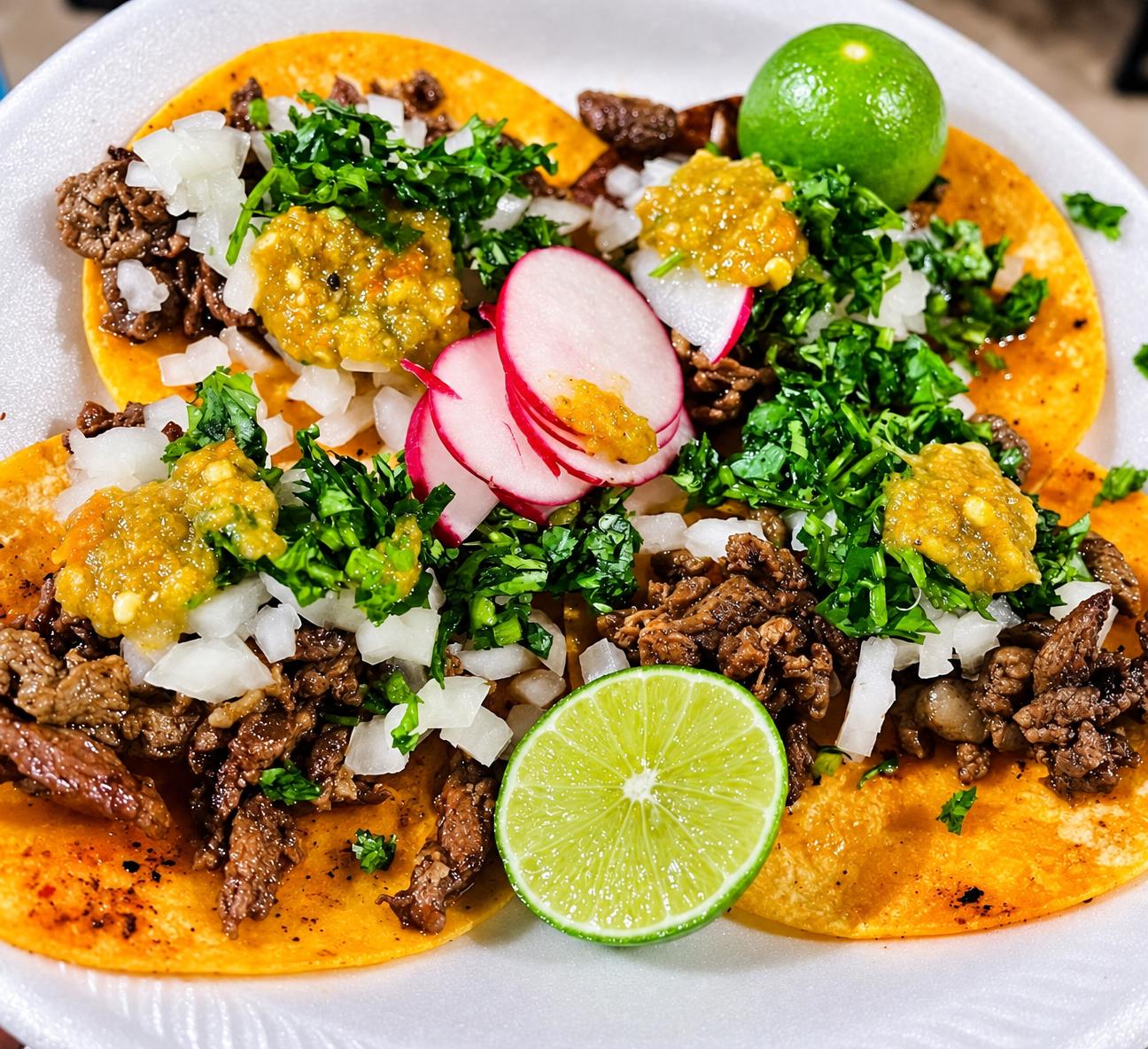 Street tacos with cilantro, onion, radish, salsa and lime